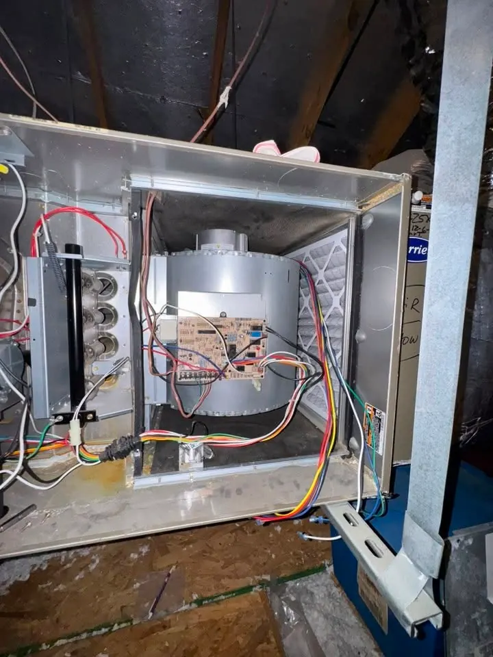 Attic gas furnace with the panel off, showing the control board and wiring we test when a furnace won't turn on.